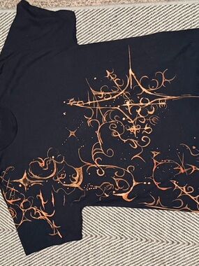 Black Graphic Tee with Copper Starburst Design